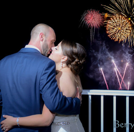 Bride and groom share a New Years kiss in front of the fireworks at Granite Links in Quincy MA