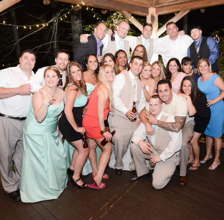 Large group shot of wedding guests on the back deck at Camp Kiwanee in Hanson MA