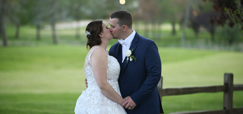 bride and groom sharing a quiet moment along a fence overlooking the golf course at The Villa in East Bridgewater MA