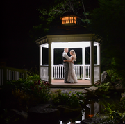 This image is of a couple standing inside the gazebo of Miraval Gardens at night with a perfect flash behind them. Miraval Gardens by Wedgewood in East Bridgewater MA is a unique hidden gem wedding venue in south eastern MA that offers gorgeous gardens, outdoor ceremonies and pristine landscaping. Weddings at Miraval Gardens stand out as memorable and unique. From Boston to Cape Cod, weddings at Miraval Gardens rise above the standard and provide stunning wedding photography opportunities.