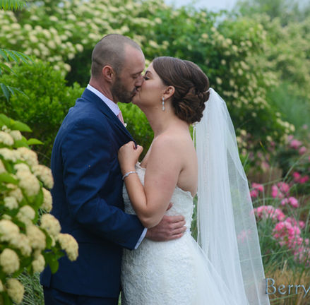 Bride and groom kiss amongst the spring blooms at Granite Links in Quincy MA