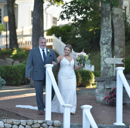 Bride and dad approaching a set of stairs at the beginning of her wedding ceremony at Bournedale Function Facility in Bourne MA