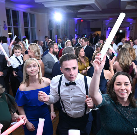 Large gathering of wedding guests having fun on the dance floor at Indian Pond in Kingston, MA