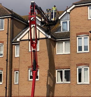 Cleaning a roof at height with powered access