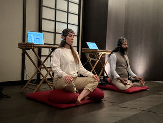 Two participants meditating with EEG and brain-computer interface — Geneva Meditation Challenge