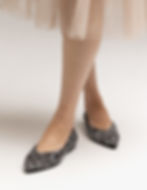 Model wearing The Pointed Confetti ballet flats by Turf, styled for holiday and festive occasions