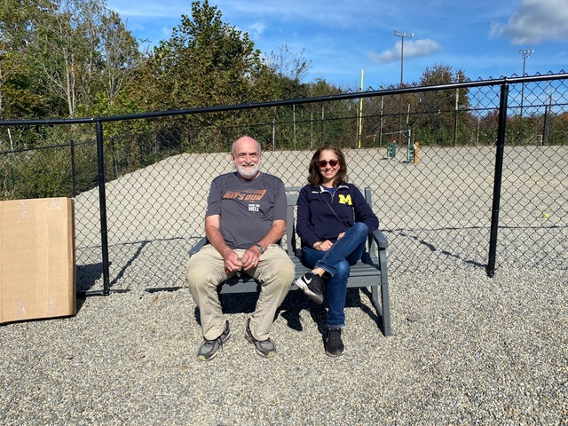 Lisa Sammataro and Jay Fowler sitting on the Trex bench