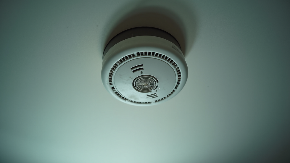 Eye-level view of a smoke detector on a ceiling