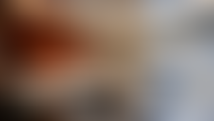 Elegant home interior featuring seamless architectural lighting integration, including warm cove lighting and recessed ceiling illumination