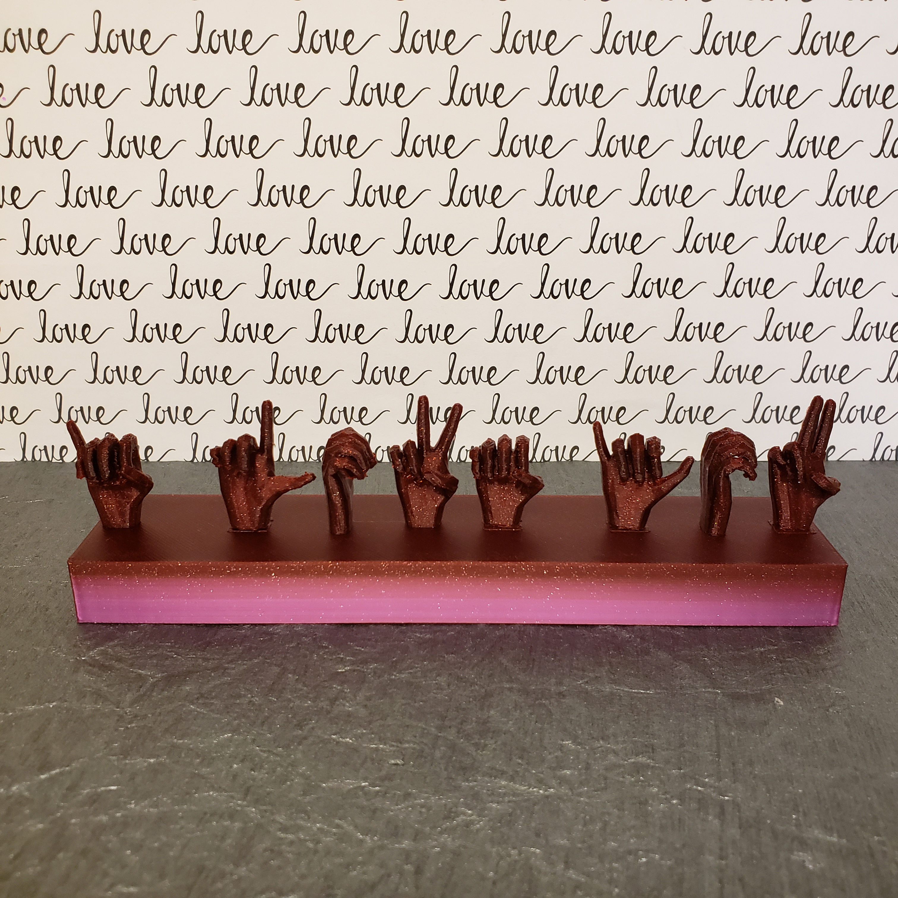3D printed stand with hand s spelling I Love You in American sign language