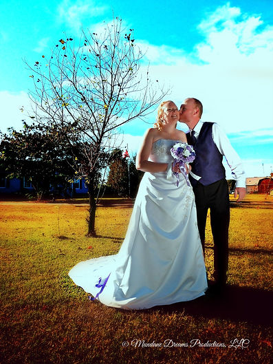 Cheri and Shane outdoor flowers kiss wm.