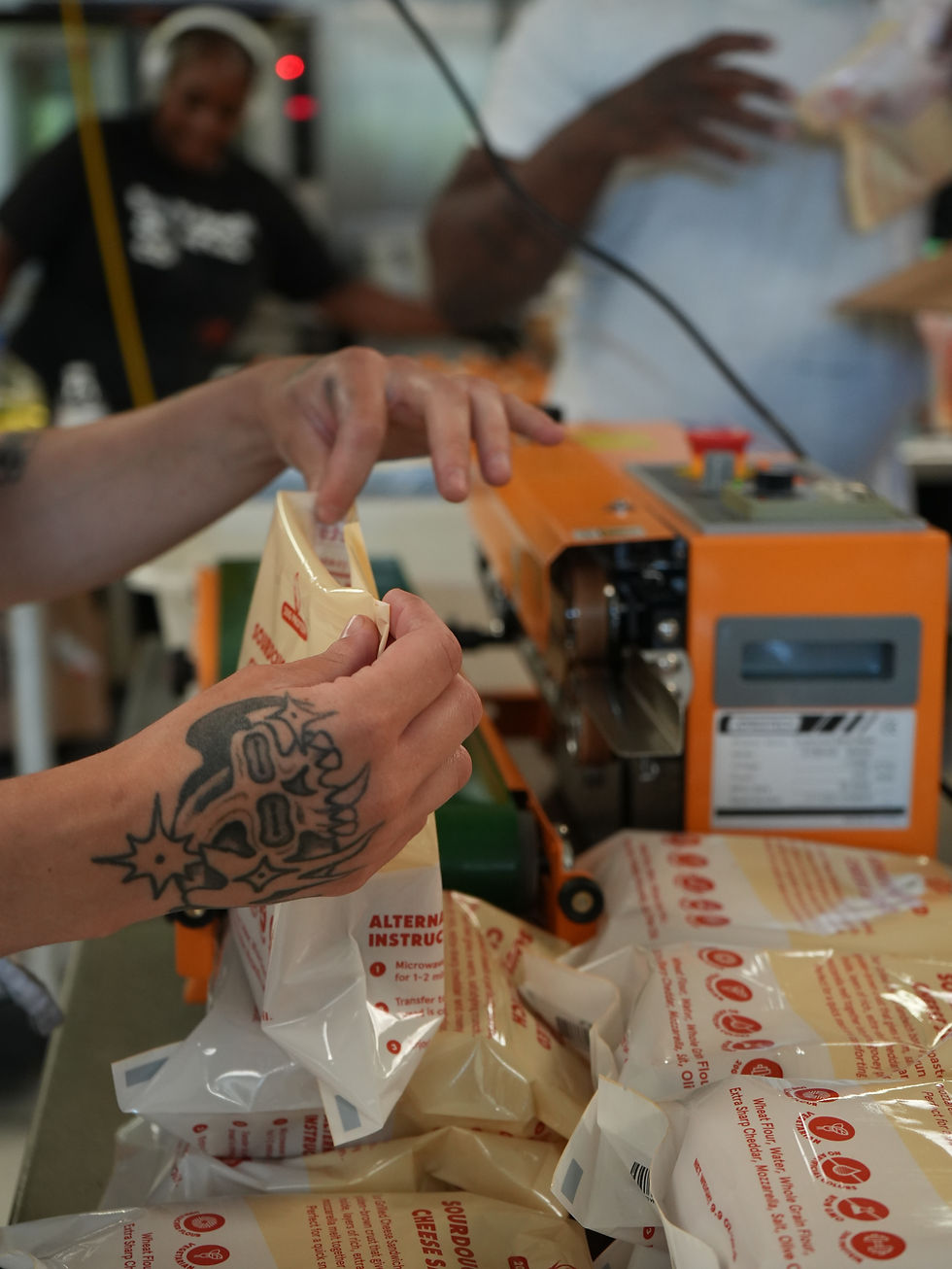 A Friendly Bread worker sealing the product