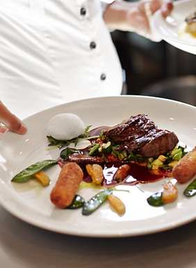 Plated courses and table settings for a catered event