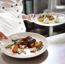 Elegant fine dining restaurant interior with sophisticated table settings.