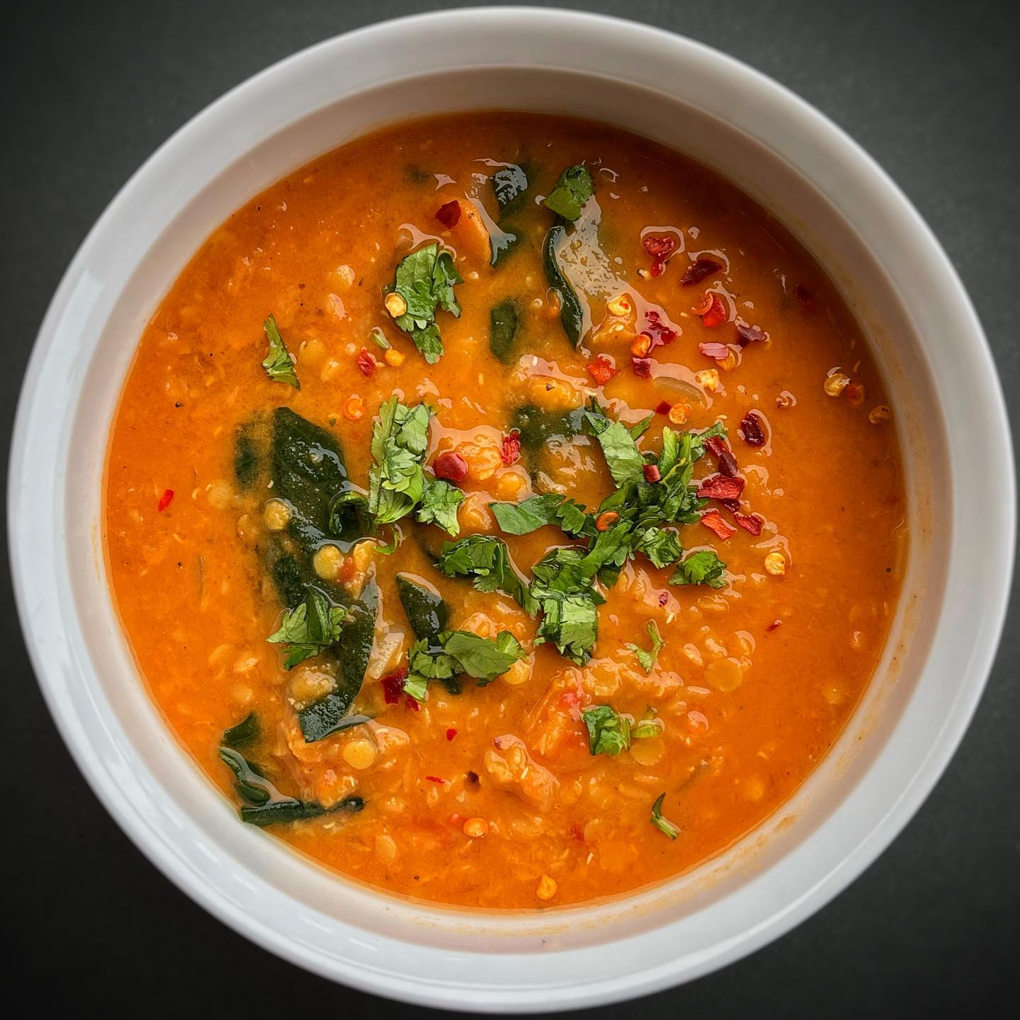 Moroccan red lentil soup with vegetables, spinach, cilantro, and warming spices