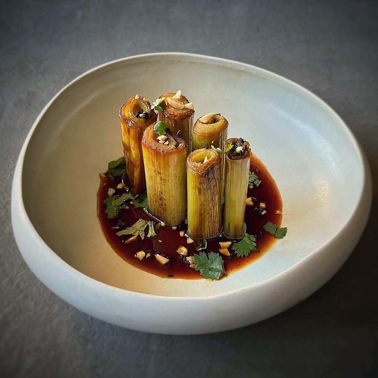 Confit leeks with gomasio, peanuts, sesame vinaigrette, and fresh cilantro