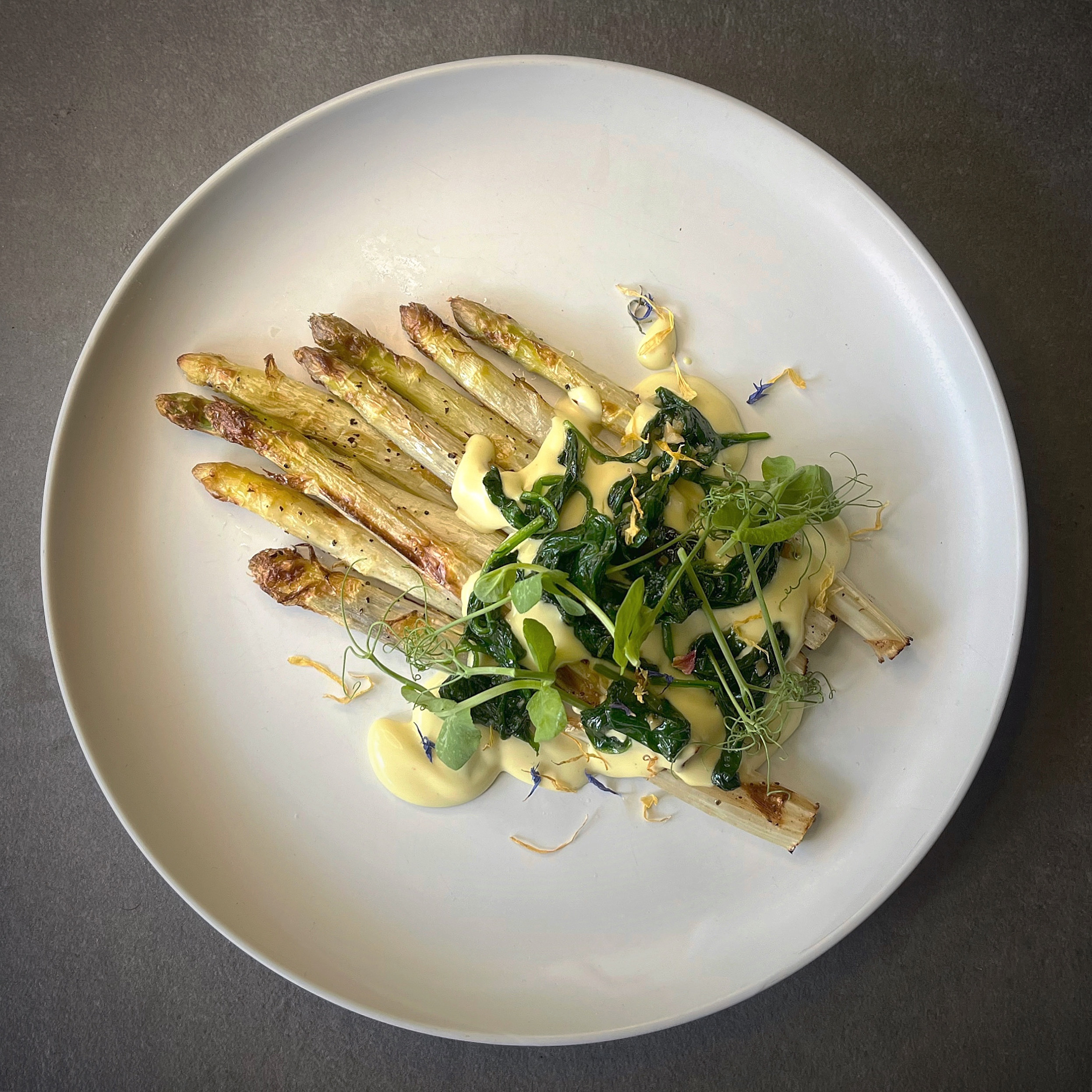 Roasted asparagus with creamy vegan miso hollandaise and garlic spinach