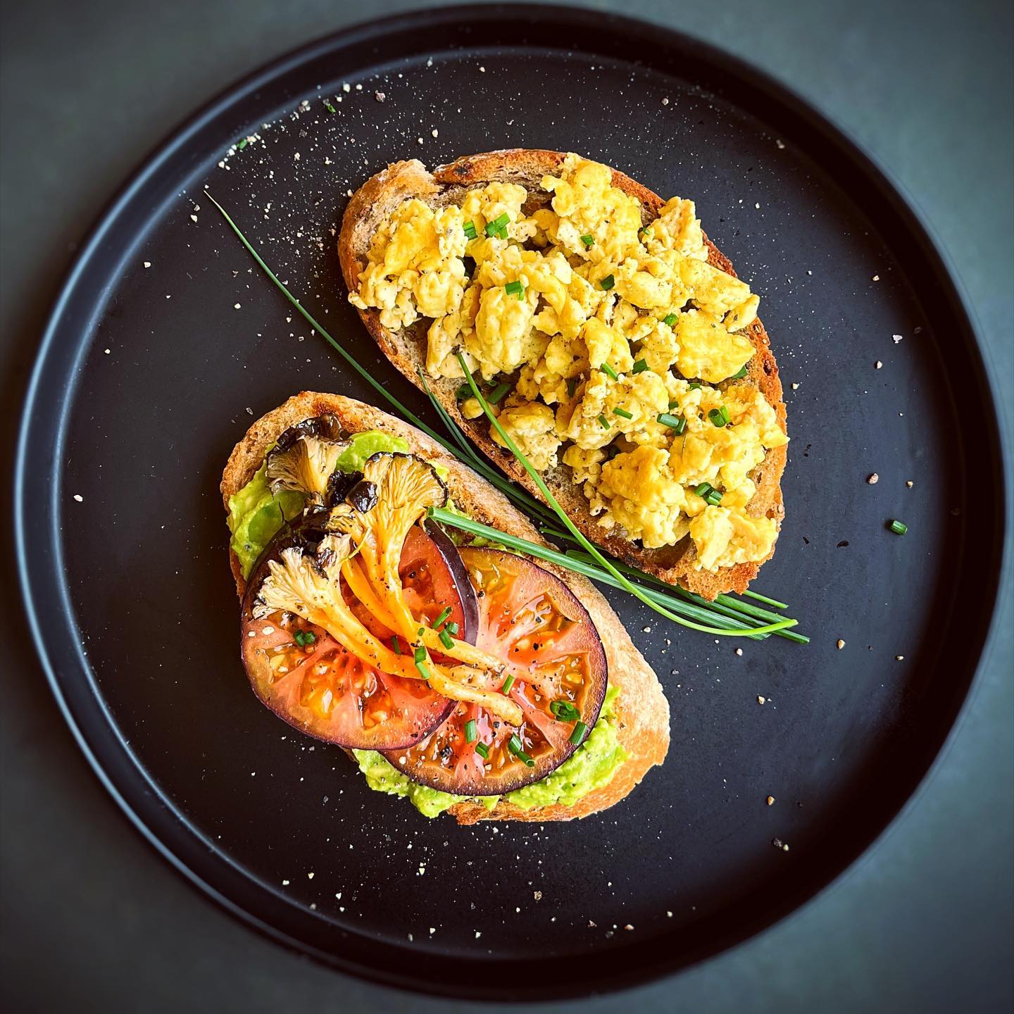 Vegan California breakfast sandwich with avocado, tomato, mushrooms, and scrambled egg