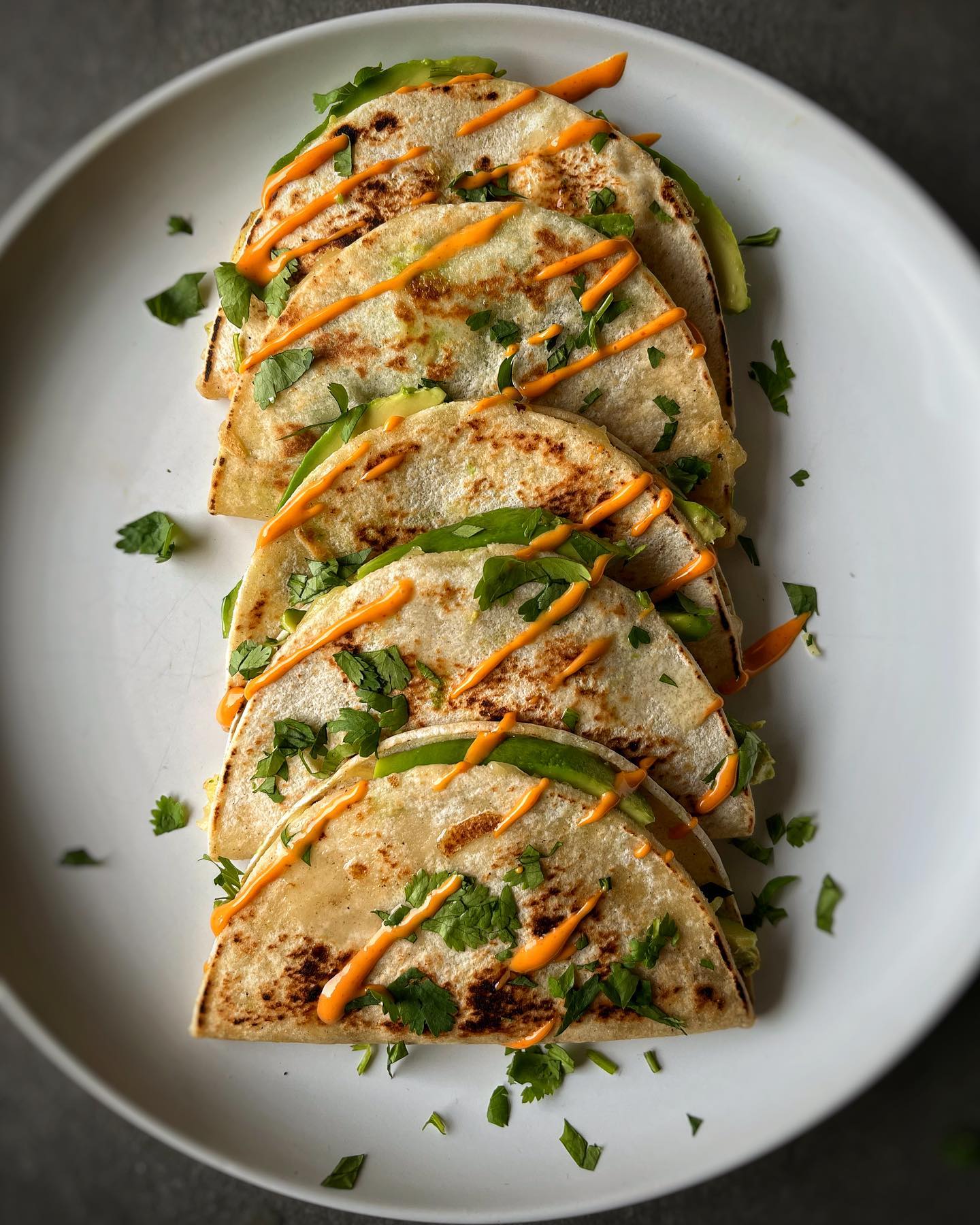 Crispy mini vegan quesadillas filled with vegetables, avocado, and dairy-free cheese