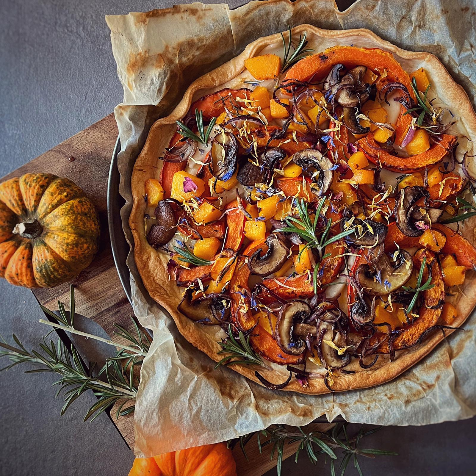 Rustic vegan pumpkin tart with butternut squash, mushrooms, red onion, and rosemary