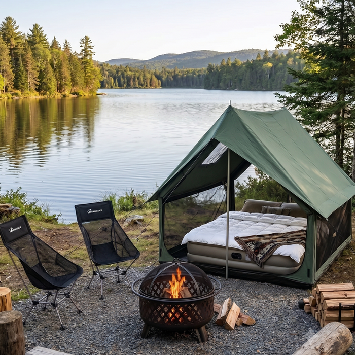 Lakeside campsite with a green tent, fire pit, and chairs