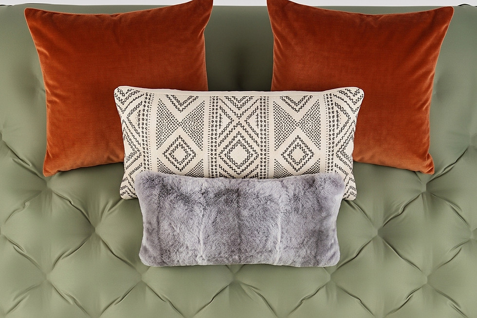 Green tufted mattress with throw pillows and a blanket