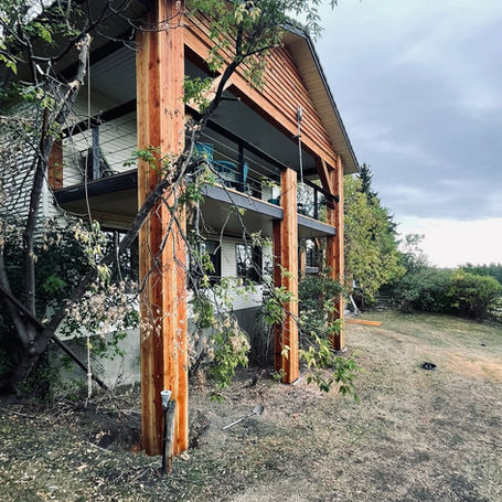 Brick ranch house transformed into rustic timber lodge.