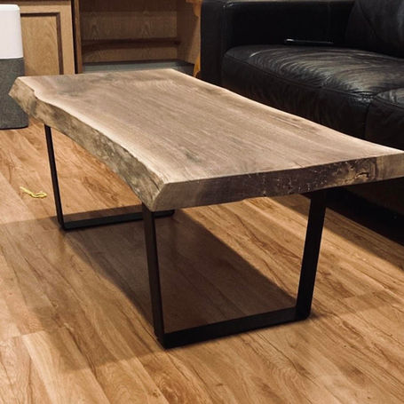 Add warmth to your home with raw wood accents like this rustic raw edge coffee table.