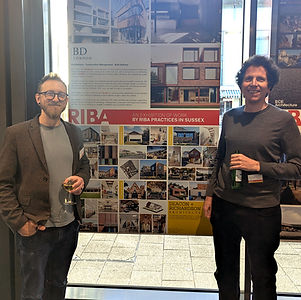 Dave Batey and Toby Richardson Standing With the Deacon and Richardson Display Board for the RIBA Sussex 2026 Exhibition