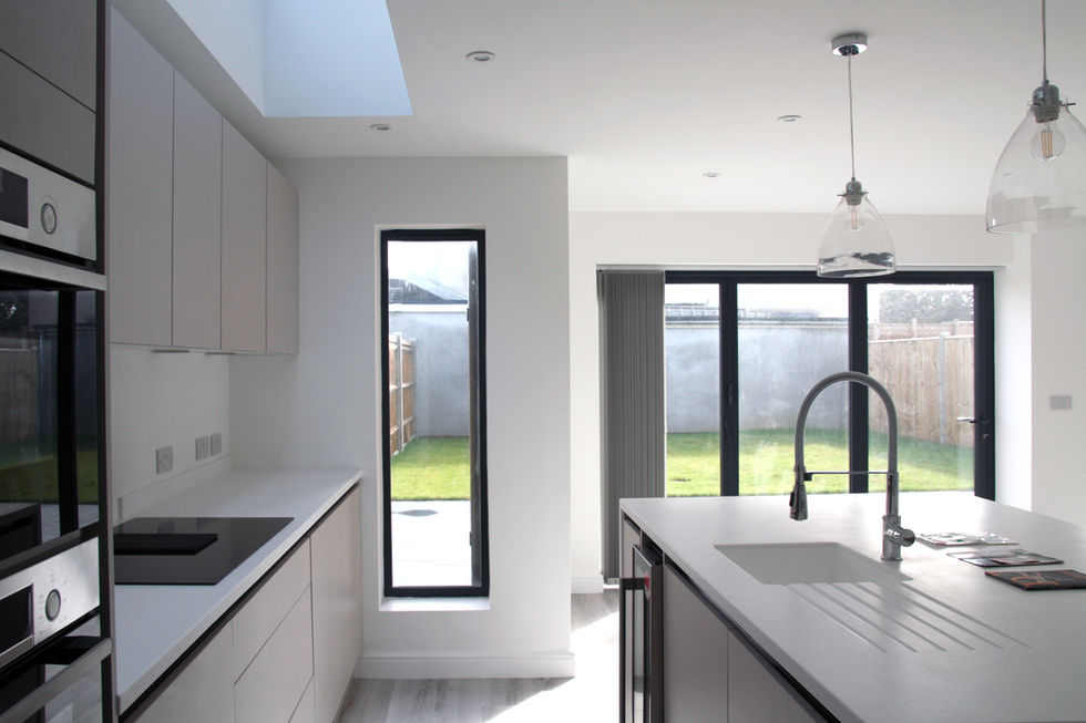 Internal kitchen photo taken facing the rear garden linked with tall glazing and doors