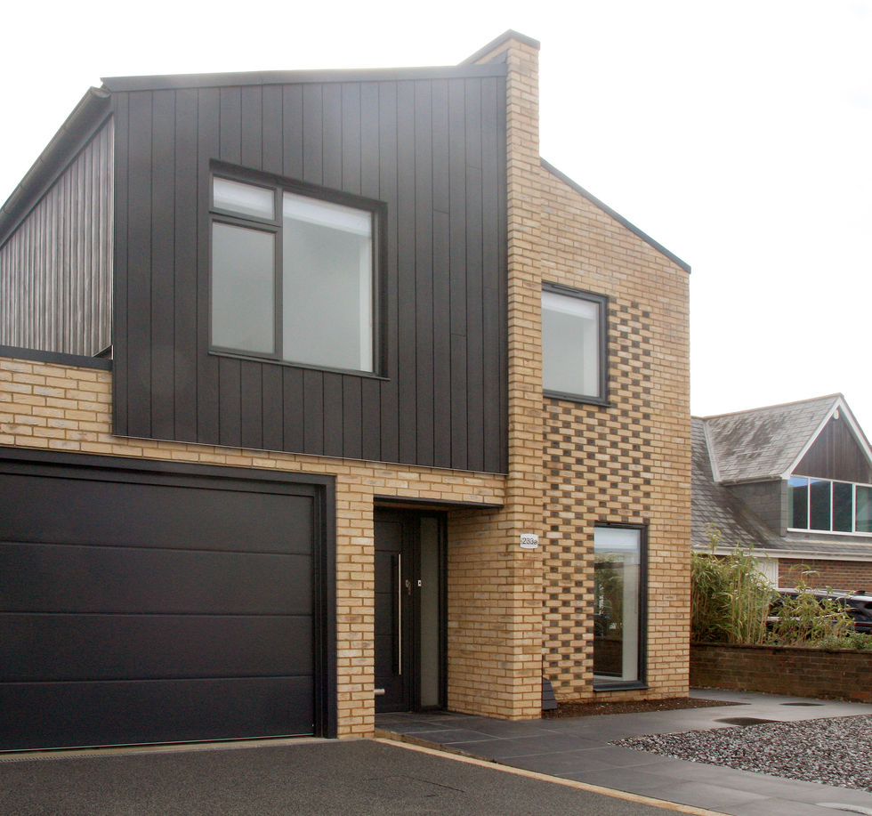 Front elevation photo of the semi-detached new-build houses in shoreham finished in buff brick and black cladding