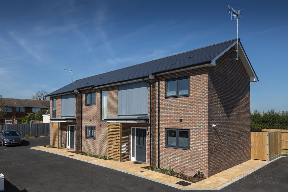 front elevation photograph of the Rectory Close houses showing the brick and Cedral cladding materials palette,.