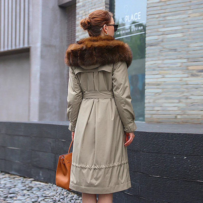 Woman wearing the Rex Rabbit Fur Coat in a casual chic outfit with leather handbag