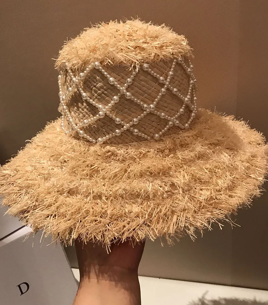 Elevate your summer style with our Pearl Elegance Raffia Straw Hat. Perfect for sun protection with a touch of elegance. Shop now!
