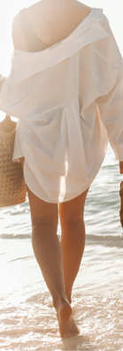 Woman in summer outfit holding jelly flat sandals and a straw bag — shop women's summer sandals and jelly flats at BC Style & Crafts