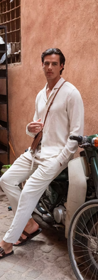 A yourng men wearing BC Style Crafts white linen button shirt and pants. 