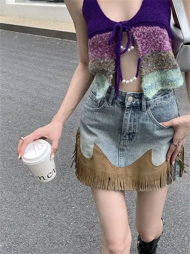 Embrace the boho spirit in Spring 2024 with this chic blue tassel denim mini skirt from BC Style & Crafts. Elevate your denim fashion with a touch of flair!