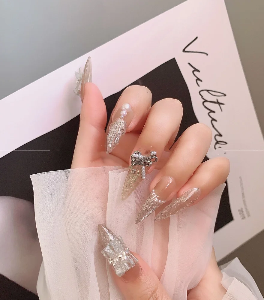 Handmade glue-on nails with charming bow tie designs, perfect for adding a touch of elegance and style to your manicure.