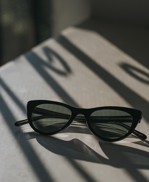 black framed sunglasses on white surface