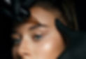 Beautician hand doing brow permanent makeup on an attractive female face_.jpg