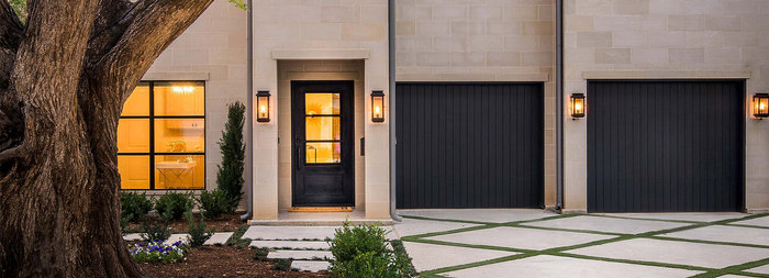 Modern entry and garage doors on new construction home