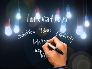 writeing words Innovation, Solutions, Ideas, Creative, Intellegence, Inspireing Vision with hanging light bulbs