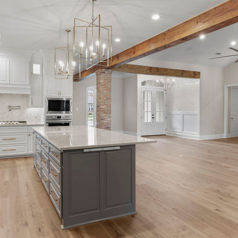 Kitchen with exposed brick and beam