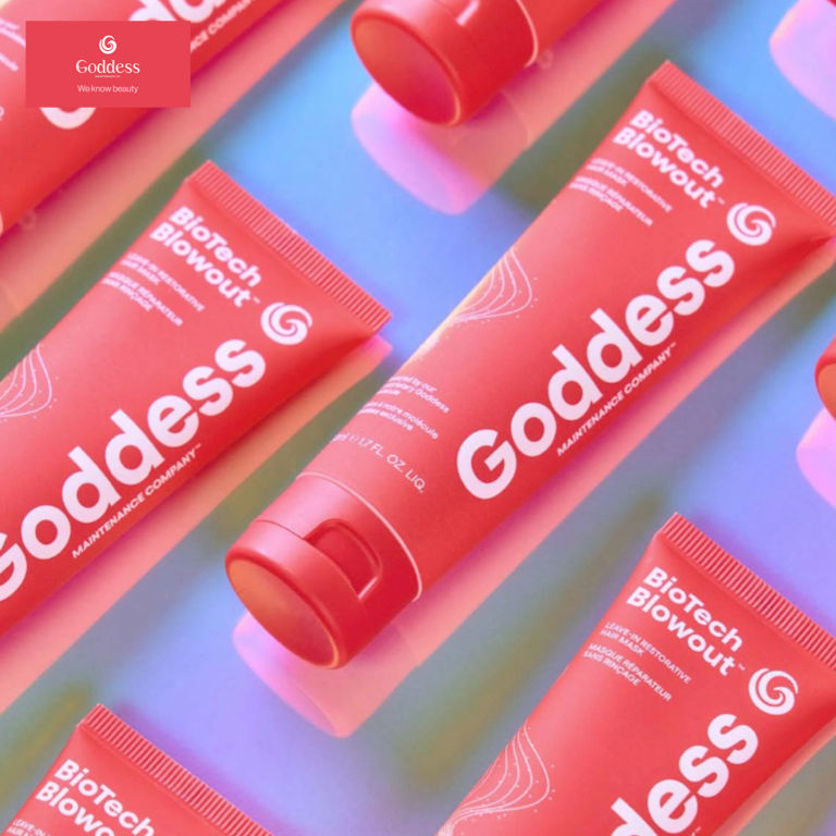 Close-up view of a hand holding a bottle of professional hair product