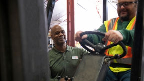 An onsite industrial athletic trainer works with an employee