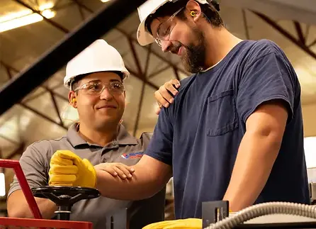 Industrial worker being helped by an onsite ISM provider.webp