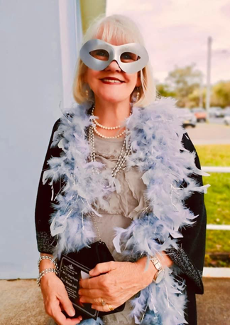 Image 8 Sonja Ridden resplendent in feathers made a grand entrance.png