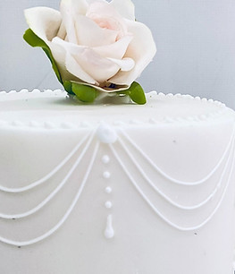 Royal icing details on a mini cake