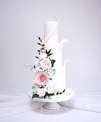 3 tiered white sail wedding cake with sugar flowers