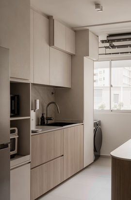 Modern minimalist kitchen with seamless cabinetry and a bold, fluid transition into the dining zone by Parallax Studio.